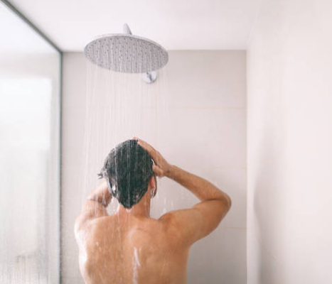 a man in the shower after a business trip