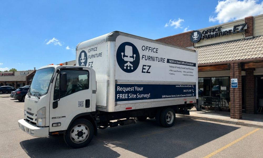 Office Furniture EZ's Colorado Springs Showroom. A delivery truck is out front loading up office furniture.