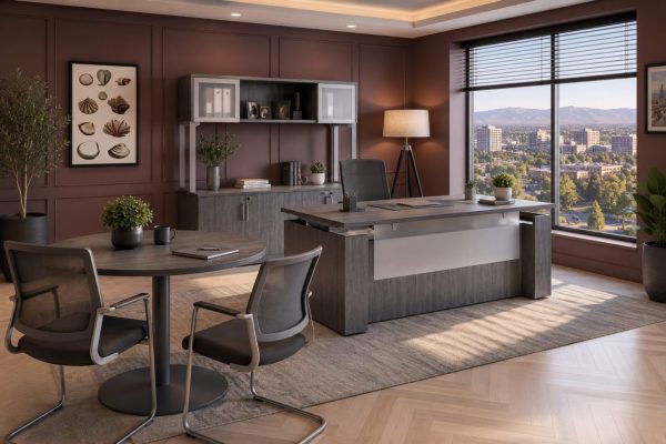 An executive office with an adjustable height table, an ergonomic chair, and a meeting table