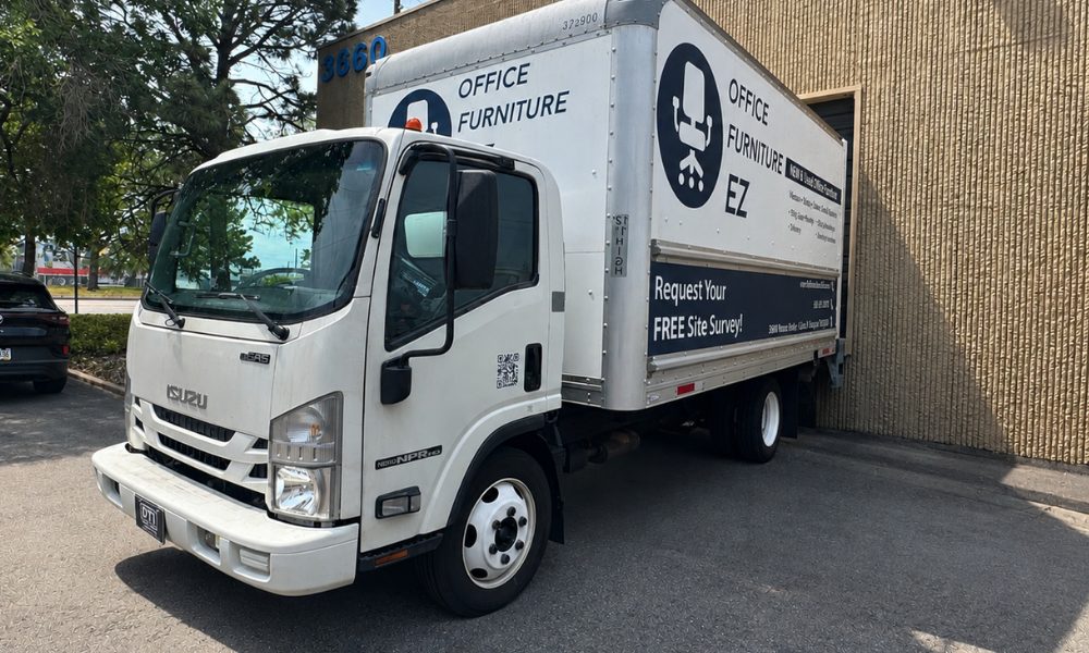 An Office Furniture EZ Delivery Truck leaving the warehouse at North Revere Street in Denver