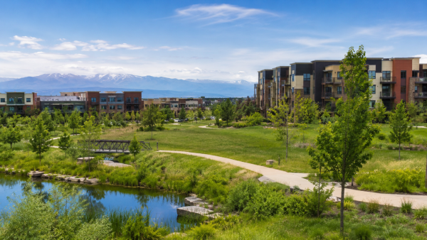 Scenic view of Central Park and Northfield in northeast Denver with green space, walking paths, and mountain views