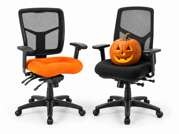 An office chair with an orange seat cushion next to an office chair with a black cushion. There is a carved pumpkin on the black cushion.