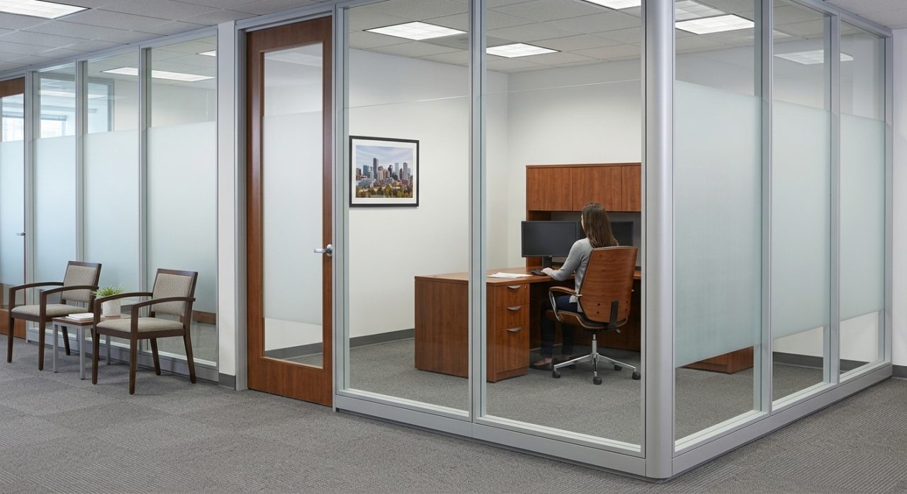 Enclosed private office with frosted glass walls and a wood-framed door